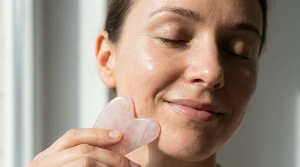 Woman using Gua Sha for jawline sculpting